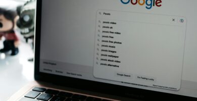 A close-up shot of a laptop displaying a Google search page with related searches visible.